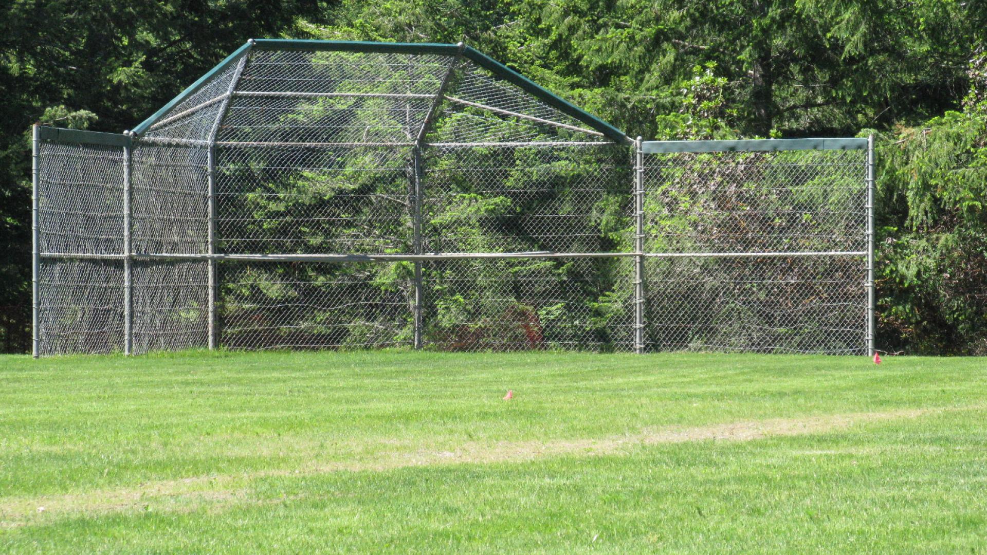 batting cage on a large field.